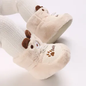 Close-up of fluffy baby winter boots with cute bear ears and paw embroidery
