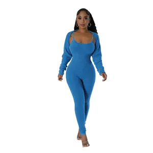 Model wearing sexy blue ribbed tight jumpsuit set with a matching long sleeve shrug