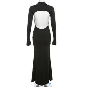 Rear view of a black long sleeve bodycon maxi dress featuring a large back cutout detail