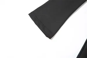 Detailed close-up view of the neatly stitched sleeve cuff on a black slim fit bodycon dress