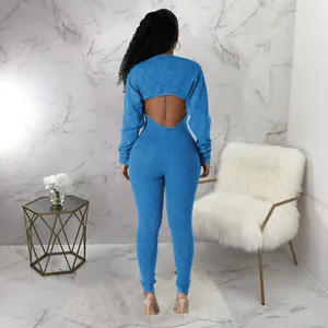 Rear view showing the stylish hollow-out back design of this sexy blue ribbed slim-fit jumpsuit