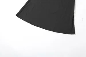 Macro view showing the high-quality hemline and stitching of a black slim-fit dress.