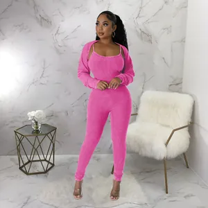 Two-piece pink ribbed jumpsuit set featuring a strappy U-neck and long sleeve bolero shrug