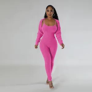 Hot pink two-piece ribbed jumpsuit set featuring matching shrug and spaghetti straps