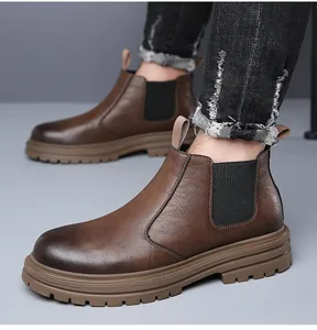 Detailed view of men's brown leather Chelsea boots with thick lug soles and elastic sides