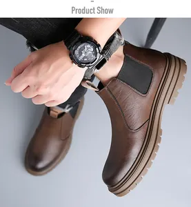 Detailed view of men's brown leather Chelsea boots worn with jeans, British style.