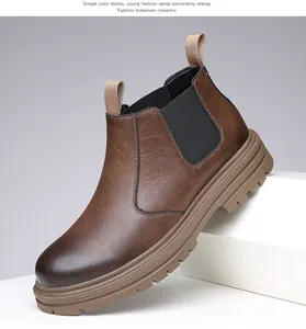 Detail of brown leather Chelsea boot with elastic side panels and thick rugged sole.