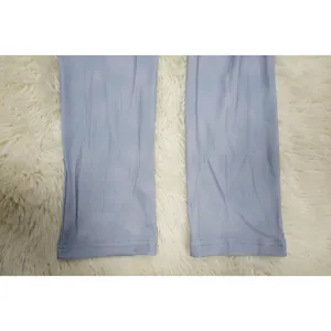 Close-up detail of the ribbed fabric hem on a light blue sexy tight jumpsuit garment
