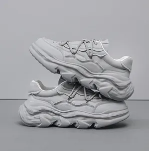 Side profile detail view of grey chunky dad sneakers with thick dissolved sole design