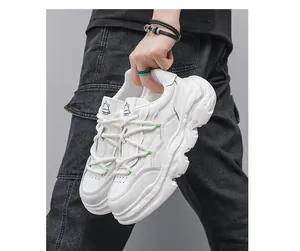 Detailed view of white chunky leather dad shoes with thick rope laces and platform sole
