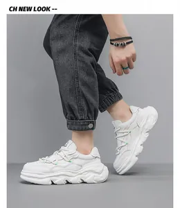 Side profile of white leather chunky sneakers with thick dissolving soles.