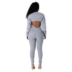 Back view detail of a grey ribbed jumpsuit set featuring a cropped long sleeve shrug top