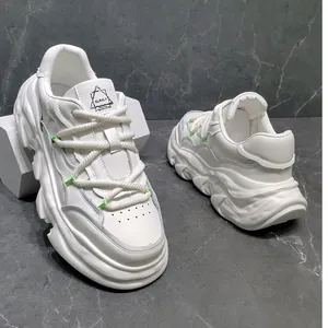 Detailed shot of white chunky leather platform sneakers featuring thick rope laces