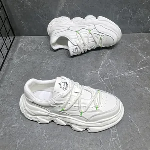 Side view of white leather platform sneakers with chunky dissolution soles and rope laces.