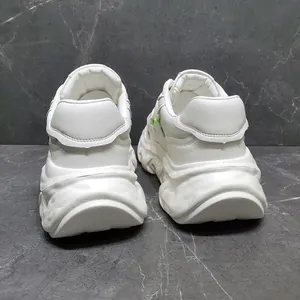 Detailed rear view of white chunky genuine leather dad sneakers with thick platform soles
