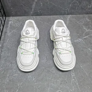Top view of white genuine leather chunky sneakers with thick dissolved soles and rope laces.