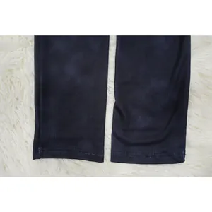 Close-up of the ribbed fabric and stitched hem of this navy blue slim fit jumpsuit.