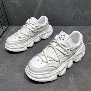 Detailed view of white leather chunky sneakers with thick wavy soles and rope laces