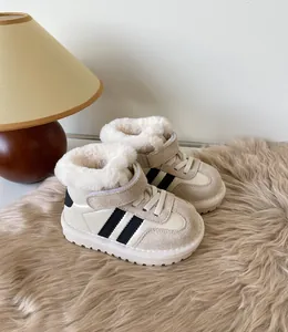 Detailed view of baby snow boots with warm faux fur lining and stripe design