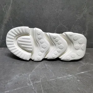 Detail view of the chunky white wavy outsole of a platform sneaker with textured grip patterns.