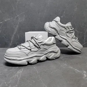 Side view of chunky platform sneakers with unique melted sole design on stone background.