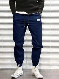 Detailed view of men's navy blue cargo joggers featuring drawstring waist and elastic cuffs