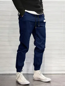 Close-up detail of men's dark blue cargo pants featuring a drawstring waist and joggers style