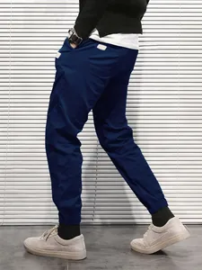 Close-up side view detail of men's casual navy blue cargo pants with elasticated cuffs