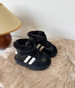Warm toddler winter snow boots in black with soft faux fur lining on a plush rug detail