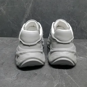 Rear view detail of grey leather chunky dad shoes with thick platform dissolved sole