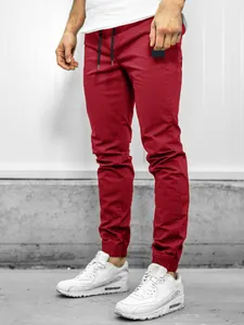 Close-up of red men's casual cargo jogger pants styled with white sports sneakers