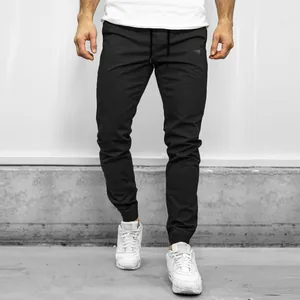 Detail shot of men's black cargo joggers with elastic cuffs and drawstring waist
