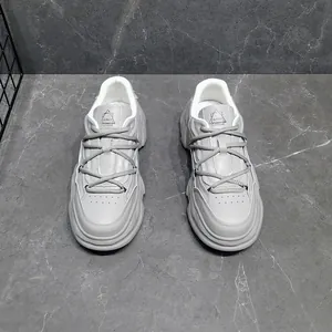 Grey chunky dad sneakers with thick platform soles and genuine leather detail for men