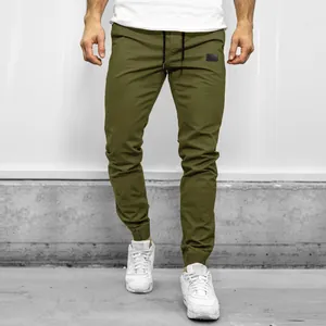 Front detailed view of men's olive green cargo joggers featuring a drawstring waist