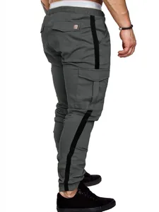 Detailed view of men's grey cargo pants with black side stripes and functional side pockets