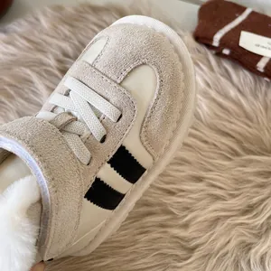 Cozy warm toddler snow boots with plush lining and stylish black stripes on beige suede.