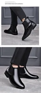 Detailed shot of black genuine leather Chelsea boots showing sleek finish and elastic side