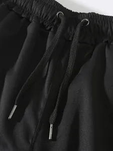 Close-up of elastic waistband with adjustable black drawstrings on men's cargo pants