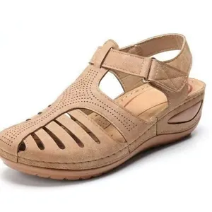 Detailed side view of beige retro closed-toe hollow sandals with wedge heel