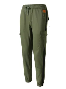 Detail front view of men's casual olive green cargo jogger pants with black side stripes