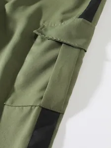 Macro view of cargo pocket and black stripe detail on olive green trousers
