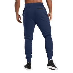Rear view of navy blue men's jogger sweatpants featuring a slim fit and ribbed ankle cuffs.