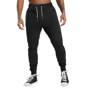 Close-up of black men's drawstring sweatpants with ribbed cuffs on model