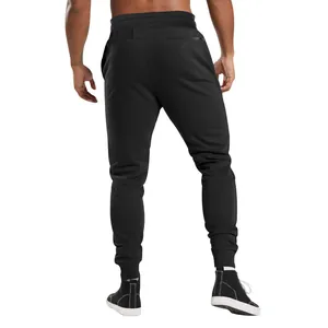 Detail view of men's slim fit black joggers with athletic ribbed cuffs from the back