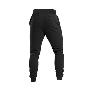 Rear view of men's breathable black sports joggers featuring elastic cuffs and pockets