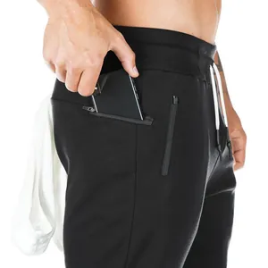 Close-up of men's black joggers showing a secure zipper pocket for phone storage