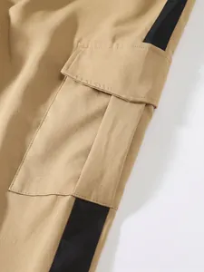 Close-up of durable khaki cargo pants pocket with stylish black side stripe detailing