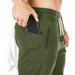 Close-up detail of olive green men's sports sweatpants featuring a functional phone pocket