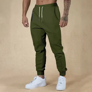 Olive green men's athletic joggers with adjustable drawstring and tapered fit detail.