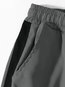 Detailed view showing the elastic waistband and side pocket of grey casual cargo pants